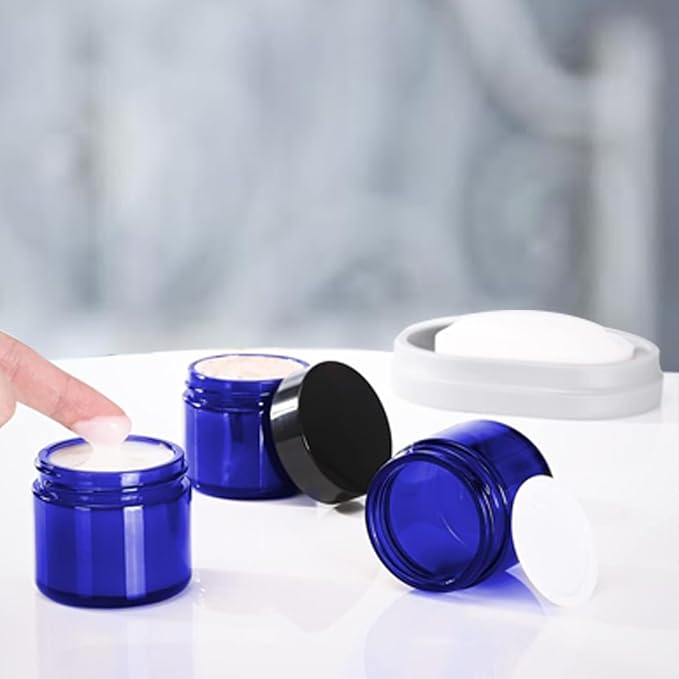 24 Pack 2 oz Round Blue Glass Cosmetic Jars with Inner Liners and Black Lids, Travel Jars, Refillable Containers for Makeup, Cream, Lotion, Sugar Scrubs, Eye Shadow, Slime, Paint, Jewelry